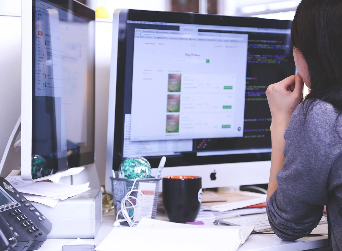 A woman reviewing a pay-per-click campaign at her computer