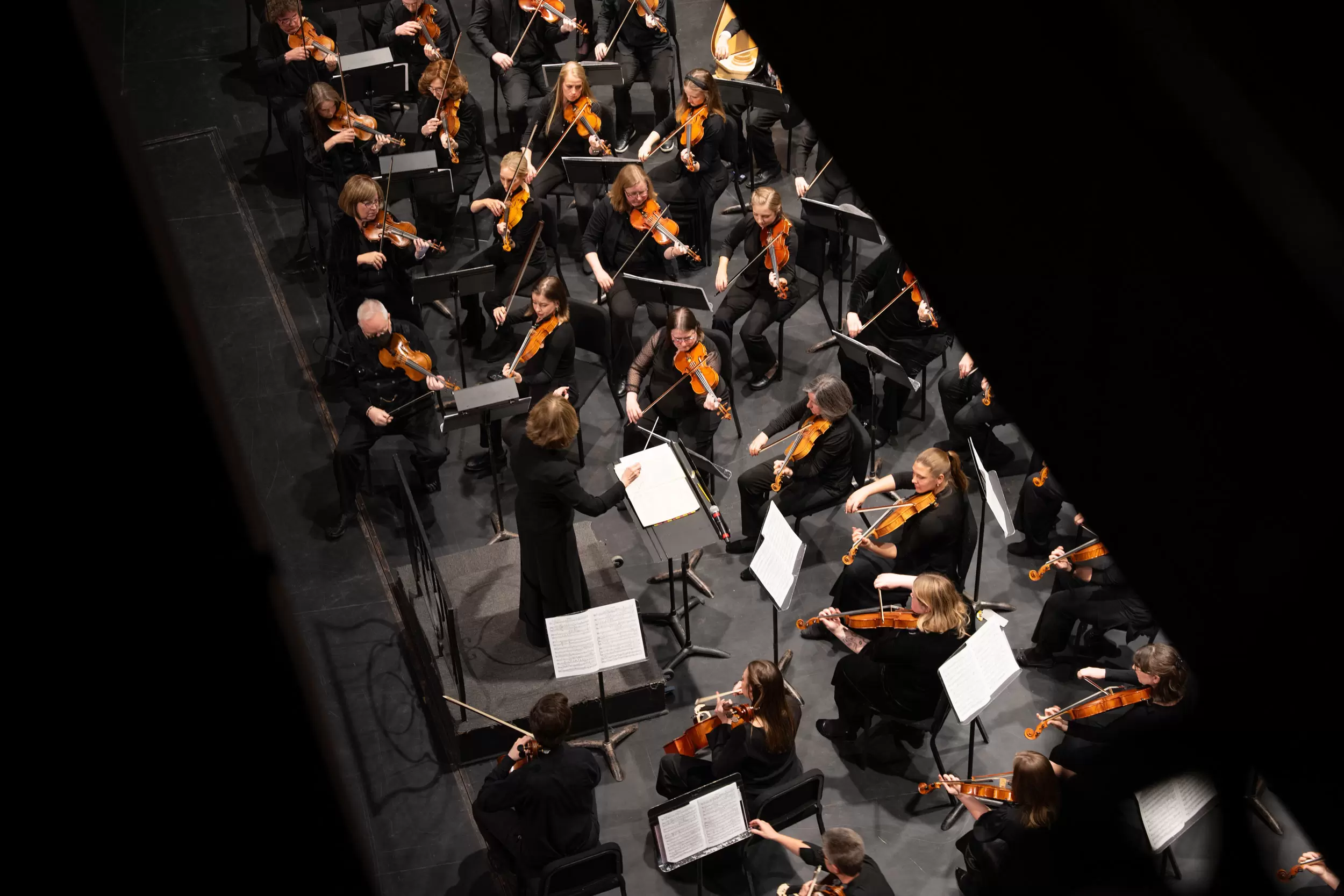 Billings Symphony orchestra and conductor performing, overhead view